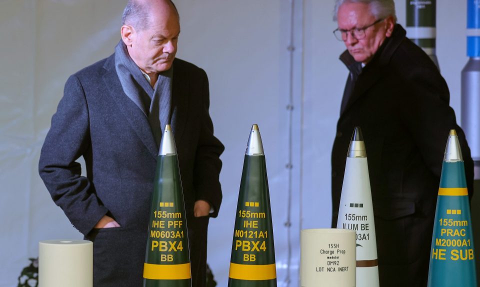 epa11147682 German Chancellor Olaf Scholz (L) and Chief Executive Officer (CEO) of German Rheinmetall AG, Armin Papperger, walk next to ammunition during the ground-breaking ceremony of a new Rheinmetall ammunition plant in Unterluess, Germany, 12 February 2024. Rheinmetall plans to invest around 300 million euros at the site in Lower Saxony. In future, the Group intends to manufacture 200,000 rounds of artillery ammunition, explosives and rocket motors there each year, according to companys informations.  EPA-EFE/FRIEDEMANN VOGEL